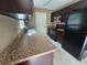 Efficient kitchen featuring dark cabinets, modern appliances, and laminate countertops at 5520 Nw 57Th St, Ocala, FL 34482