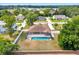 Aerial view of a home with a screened pool, surrounded by a fenced yard and mature trees at 6307 Se 8Th Ln, Ocala, FL 34472