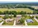 Aerial view of property with a screened pool, landscaped yard and proximity to lush green space at 6307 Se 8Th Ln, Ocala, FL 34472