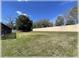 Spacious backyard with a tall privacy wall, offering ample space for recreation and outdoor living at 6307 Se 8Th Ln, Ocala, FL 34472