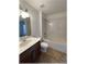 Well-lit bathroom featuring a vanity, mirror, toilet, and tiled tub with shower, creating a functional space at 6307 Se 8Th Ln, Ocala, FL 34472