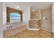 Bathroom featuring a soaking tub, shower, and stone accent wall at 6307 Se 8Th Ln, Ocala, FL 34472