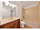 Well-lit bathroom with a large vanity, and a bathtub-shower combo with neutral tile surround at 6307 Se 8Th Ln, Ocala, FL 34472
