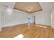 Spacious bedroom with hardwood floors, tray ceiling, and access to the backyard at 6307 Se 8Th Ln, Ocala, FL 34472
