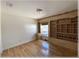 Bright bedroom featuring hardwood floors, built-in shelving, and a small desk area at 6307 Se 8Th Ln, Ocala, FL 34472