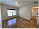 Bedroom featuring wood floors, natural light, closet, and a view into other areas of the house at 6307 Se 8Th Ln, Ocala, FL 34472