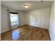 Bright bedroom features hardwood floors, a window, and built-in closets with plenty of storage at 6307 Se 8Th Ln, Ocala, FL 34472