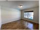Bright bedroom with hardwood floors and a view of the pool, creating a serene and inviting atmosphere at 6307 Se 8Th Ln, Ocala, FL 34472