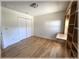 Bright bedroom with hardwood floors, built-in shelving, and a double closet, creating a versatile and organized space at 6307 Se 8Th Ln, Ocala, FL 34472