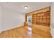Bedroom with hardwood floors, a built-in desk, and custom shelving at 6307 Se 8Th Ln, Ocala, FL 34472