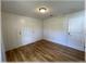 Clean bedroom featuring hardwood floors, built-in wall storage, and a white door, offering a minimalist and functional space at 6307 Se 8Th Ln, Ocala, FL 34472