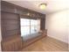 Bedroom featuring a window seat with storage, built-in shelving, and a hardwood floor at 6307 Se 8Th Ln, Ocala, FL 34472