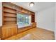 Bedroom with custom built-in shelving, window seat and view of backyard pool at 6307 Se 8Th Ln, Ocala, FL 34472
