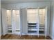 Modern open closet with shelves, hanging rods and drawers with doors open revealing white interiors at 6307 Se 8Th Ln, Ocala, FL 34472