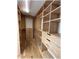 Walk-in closet with custom built-in shelves, drawers, and wood flooring at 6307 Se 8Th Ln, Ocala, FL 34472