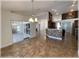 Open floor plan dining area with a kitchen island, custom wine rack, and access to the lanai at 6307 Se 8Th Ln, Ocala, FL 34472