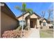 Well-maintained home exterior featuring a palm tree, lush landscaping, and a covered entrance at 6307 Se 8Th Ln, Ocala, FL 34472
