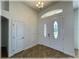 Bright foyer featuring double entry doors, a chandelier, and neutral decor with tile flooring at 6307 Se 8Th Ln, Ocala, FL 34472