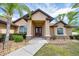 Inviting front entrance of home featuring a well-maintained lawn and double door entry at 6307 Se 8Th Ln, Ocala, FL 34472