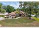 Charming single-story home featuring a well-manicured lawn and beautiful mature trees at 6307 Se 8Th Ln, Ocala, FL 34472
