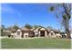 Charming single-story home featuring a well-manicured lawn, mature trees, and a welcoming double-door entrance at 6307 Se 8Th Ln, Ocala, FL 34472
