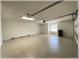 Spacious two car garage featuring sealed concrete floors with automatic overhead door, offering ample parking and storage at 6307 Se 8Th Ln, Ocala, FL 34472