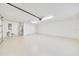 This is a bright and spacious three-car garage with epoxy floors, a water heater, electrical panel, and plenty of storage space at 6307 Se 8Th Ln, Ocala, FL 34472