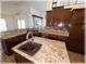Updated kitchen featuring granite countertops, dark wood cabinetry, and a kitchen island sink at 6307 Se 8Th Ln, Ocala, FL 34472