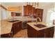 Beautiful kitchen featuring granite countertops, stainless steel appliances and dark wood cabinets at 6307 Se 8Th Ln, Ocala, FL 34472