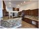 Open kitchen with granite countertops, stainless steel appliances, and dark wood cabinets at 6307 Se 8Th Ln, Ocala, FL 34472