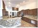 Open kitchen with granite countertops, stainless steel appliances, and brick-style backsplash at 6307 Se 8Th Ln, Ocala, FL 34472