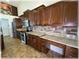 Well-equipped kitchen featuring granite counters, stainless appliances, wine rack, and dark wood cabinetry at 6307 Se 8Th Ln, Ocala, FL 34472