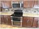Close-up of kitchen stainless double oven, range and microwave with tiled backsplash at 6307 Se 8Th Ln, Ocala, FL 34472