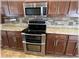 Stainless double oven and microwave with stone backsplash and granite countertops in the kitchen at 6307 Se 8Th Ln, Ocala, FL 34472