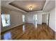 Spacious living room featuring wood floors, crown molding, and views into other rooms at 6307 Se 8Th Ln, Ocala, FL 34472