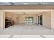 Enjoy this outdoor covered patio, tile floor, ceiling fan, and outdoor kitchen with a stainless steel sink and gas cooktop at 6307 Se 8Th Ln, Ocala, FL 34472