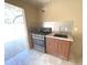 This outdoor kitchen includes a gas cooktop, sink, and storage located just outside the covered patio for easy access at 6307 Se 8Th Ln, Ocala, FL 34472