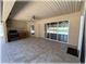 This covered patio features a granite-topped counter, built-in grill, and tile flooring at 6307 Se 8Th Ln, Ocala, FL 34472