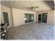 Enjoy this covered patio with tile flooring, ceiling fan and exterior door to backyard at 6307 Se 8Th Ln, Ocala, FL 34472