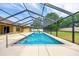 The home features a stunning screened-in pool with a slide surrounded by lush landscaping and plenty of space for outdoor entertaining at 6307 Se 8Th Ln, Ocala, FL 34472