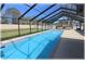Inviting screened-in pool with clear blue water offers a refreshing and private outdoor oasis, perfect for relaxation at 6307 Se 8Th Ln, Ocala, FL 34472