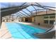 Enclosed pool with slide, sun-covered with room to relax poolside at 6307 Se 8Th Ln, Ocala, FL 34472