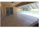 Covered patio space leading to a screened-in pool, offering a seamless transition to outdoor relaxation and recreation at 6307 Se 8Th Ln, Ocala, FL 34472