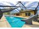The house comes complete with a screened-in pool featuring a built-in slide and is surrounded by lush landscaping at 6307 Se 8Th Ln, Ocala, FL 34472