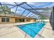 An inviting pool with a screened enclosure, perfect for relaxation and entertainment at 6307 Se 8Th Ln, Ocala, FL 34472