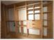 Spacious walk-in closet with wooden shelving, multiple cubbies, drawers, and a closet rod at 6307 Se 8Th Ln, Ocala, FL 34472
