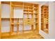 Walk-in closet with custom wood shelving, drawers, and a mirror at 6307 Se 8Th Ln, Ocala, FL 34472