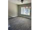 Open living room with gray wood flooring, and bright window with an outside view at 734 Nw 57Th Ave, Ocala, FL 34482