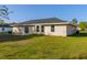 Spacious backyard with sliding glass doors and a well-maintained lawn at 75 Pine Crse, Ocala, FL 34472
