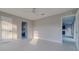 Bedroom with white plank floors, neutral walls and views into bathroom and hallway at 75 Pine Crse, Ocala, FL 34472